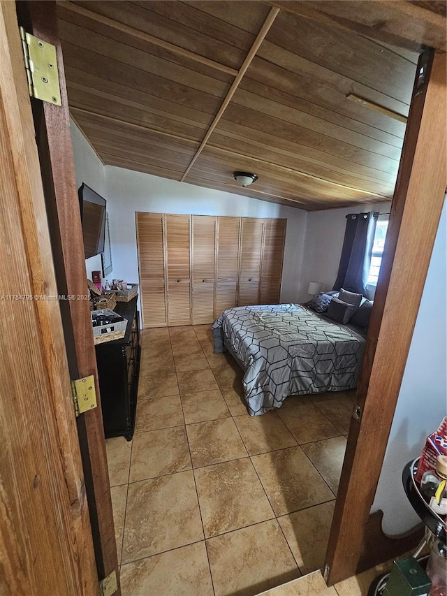 tiled bedroom featuring wood ceiling