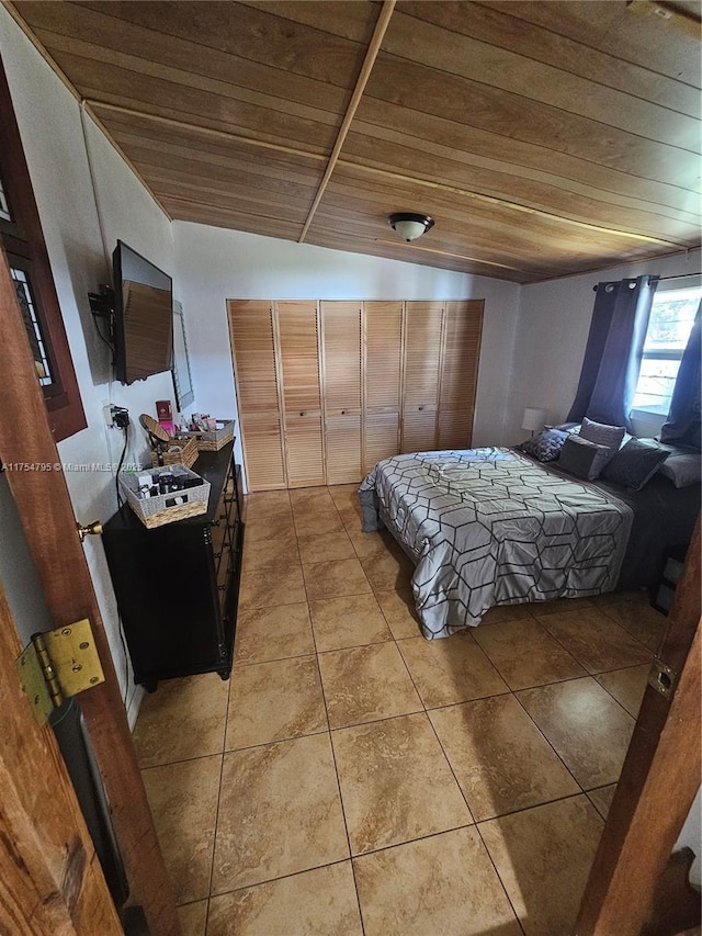 bedroom featuring vaulted ceiling, wooden ceiling, and light tile patterned flooring