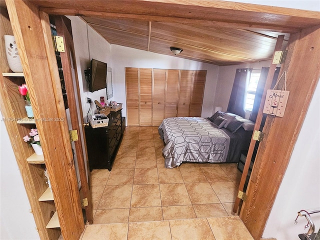 bedroom with wooden ceiling and light tile patterned floors