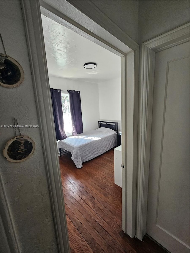 bedroom with dark wood finished floors