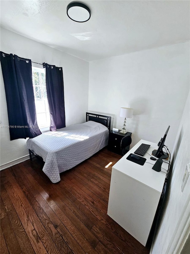 bedroom with hardwood / wood-style flooring