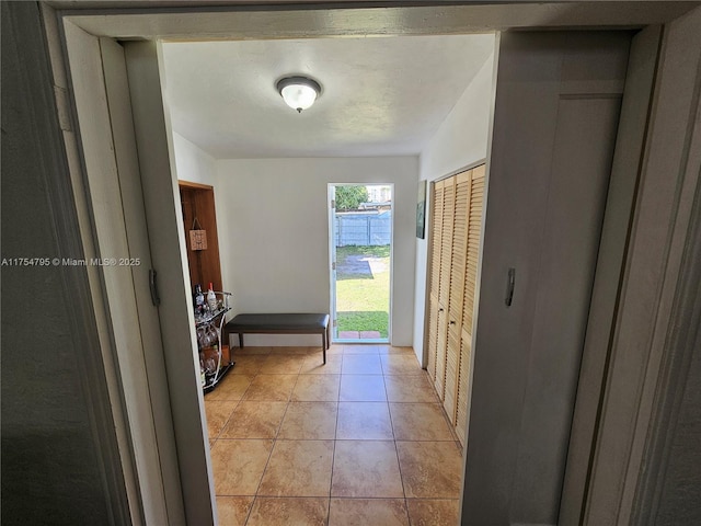 entryway with light tile patterned floors