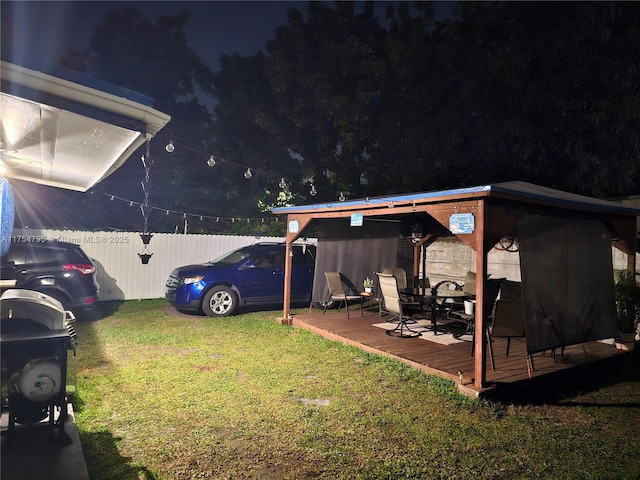 view of yard with a gazebo, fence, and a wooden deck