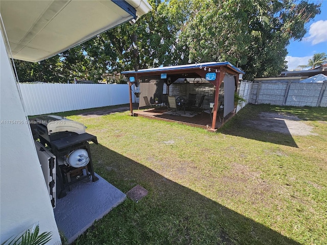 view of yard featuring a fenced backyard and a deck