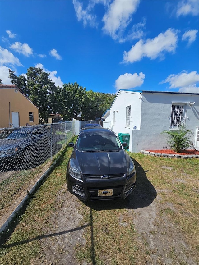 view of side of property featuring fence