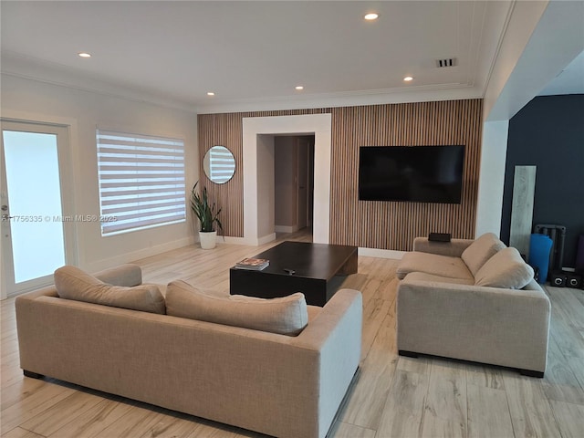 living area with recessed lighting, crown molding, and baseboards