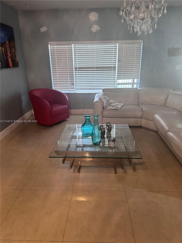 tiled living area with a notable chandelier and baseboards