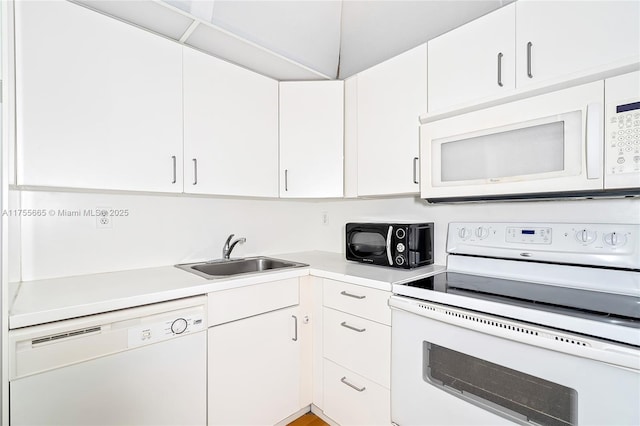 kitchen featuring light countertops, white appliances, a sink, and white cabinets