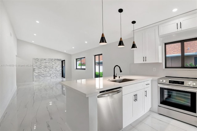 kitchen with stainless steel appliances, a peninsula, a sink, white cabinets, and marble finish floor