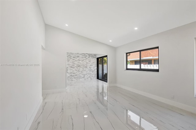 unfurnished room with recessed lighting, vaulted ceiling, and baseboards