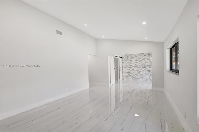 spare room with marble finish floor, recessed lighting, lofted ceiling, visible vents, and baseboards