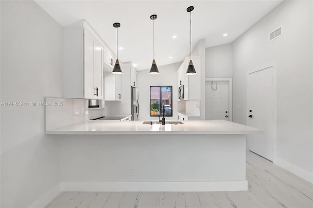 kitchen featuring baseboards, visible vents, a peninsula, light countertops, and a sink