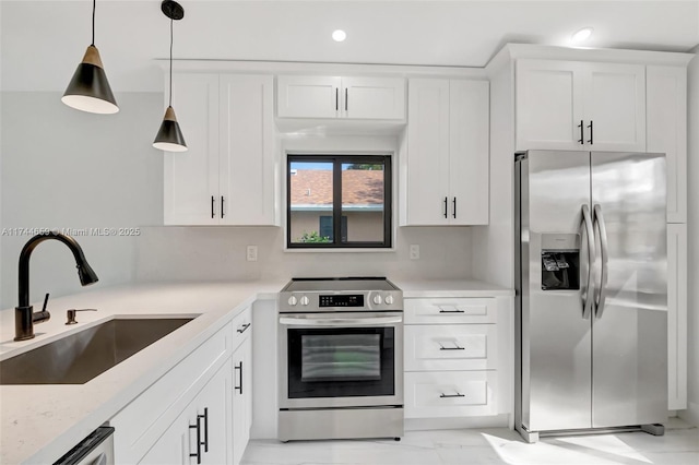 kitchen featuring white cabinets, hanging light fixtures, marble finish floor, stainless steel appliances, and a sink