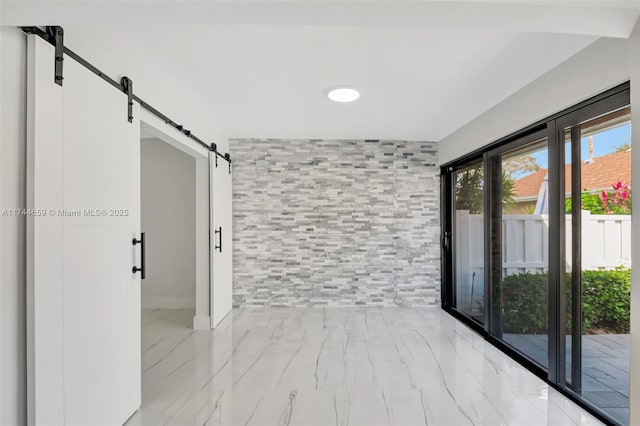 unfurnished room with a barn door