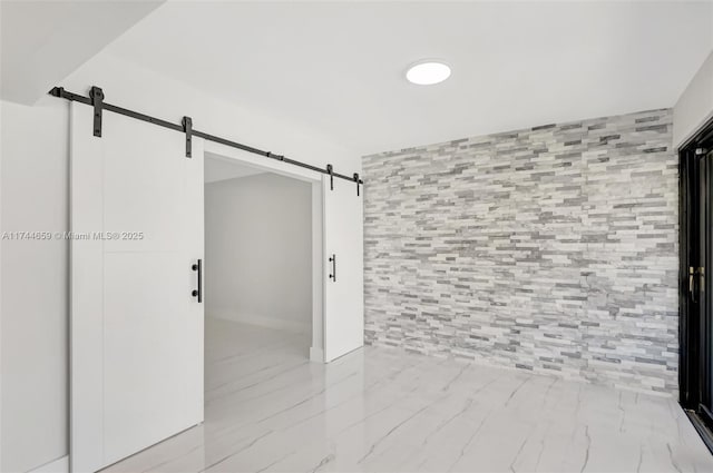 unfurnished room with a barn door