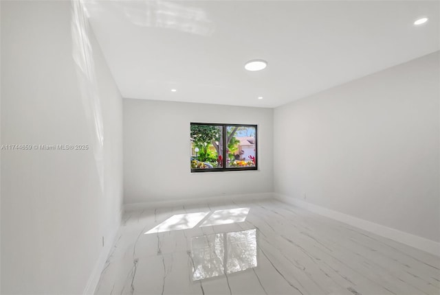 spare room featuring baseboards and recessed lighting