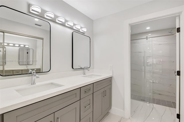 bathroom featuring marble finish floor, double vanity, a sink, and a marble finish shower