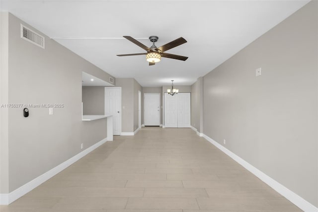 hallway featuring baseboards, visible vents, and a chandelier