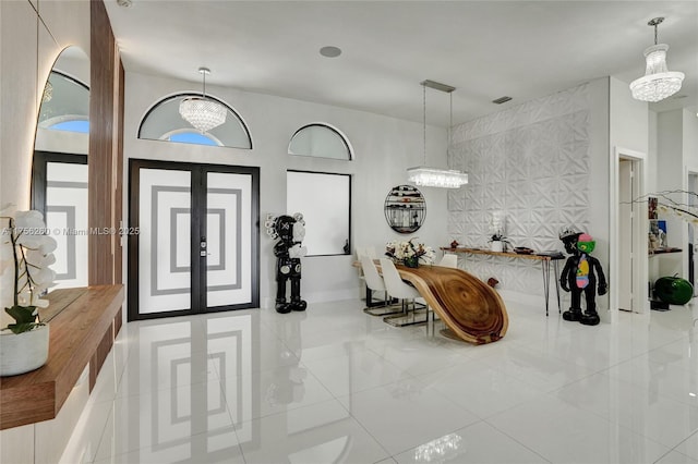 entryway featuring an accent wall, french doors, visible vents, and tile patterned floors