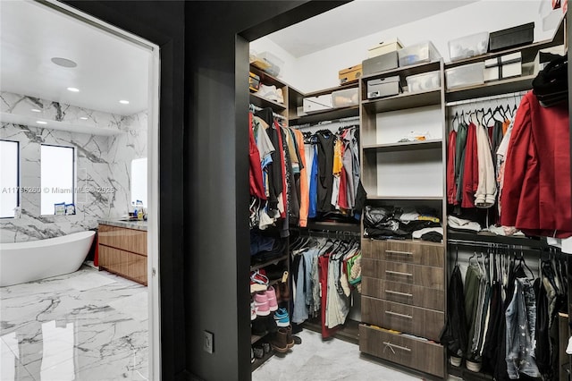 spacious closet with marble finish floor