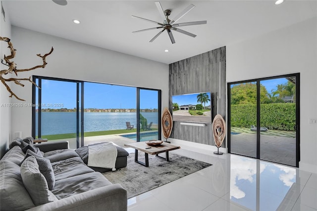 living room featuring tile patterned flooring, a ceiling fan, and recessed lighting