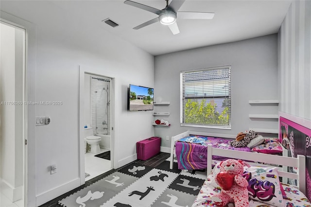 bedroom featuring ensuite bathroom, a ceiling fan, visible vents, and baseboards