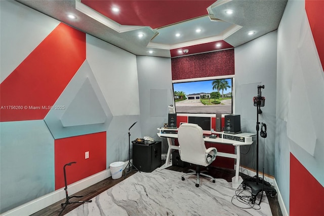 office space featuring baseboards, a tray ceiling, wood finished floors, and recessed lighting