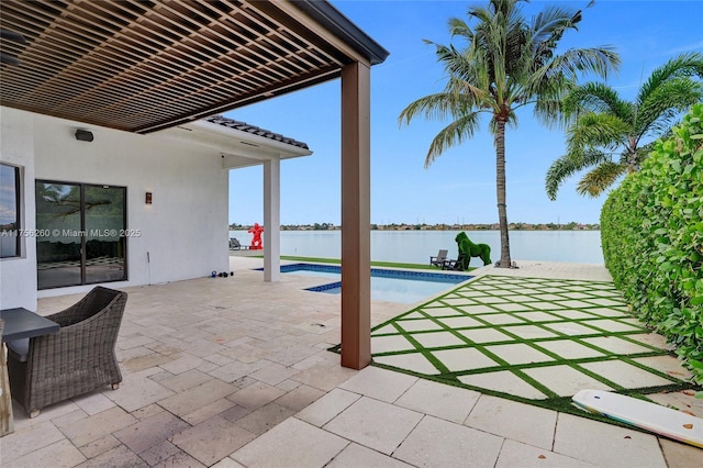 view of patio with a water view and a fenced in pool