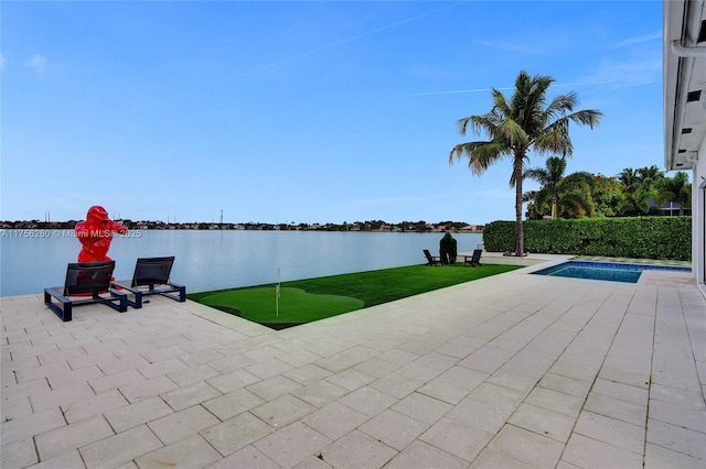 view of patio / terrace with a fenced in pool and a water view