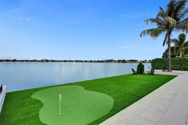 view of property's community with a water view and a yard