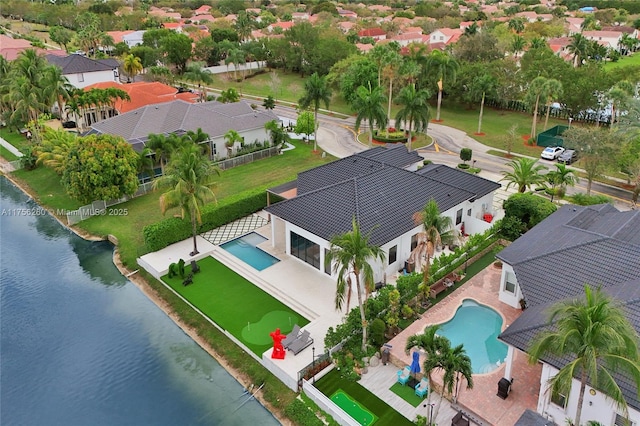 birds eye view of property with a water view and a residential view