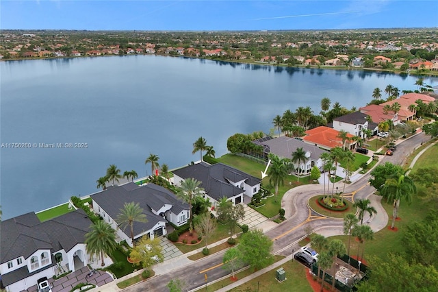 bird's eye view featuring a water view and a residential view