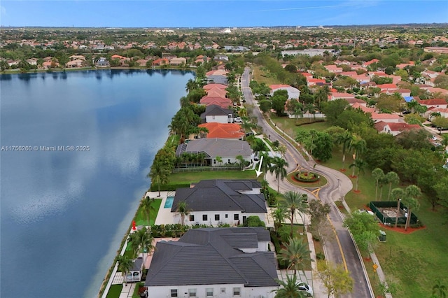 birds eye view of property with a water view and a residential view