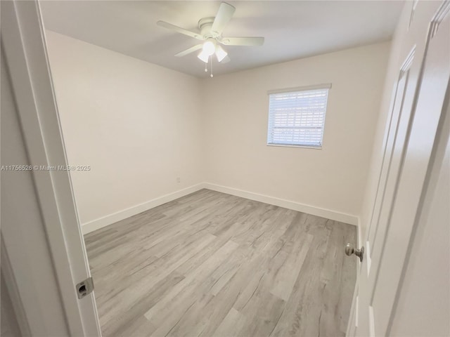 unfurnished room featuring ceiling fan, light wood-style flooring, and baseboards