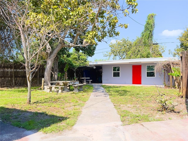 single story home featuring fence, a front lawn, and stucco siding