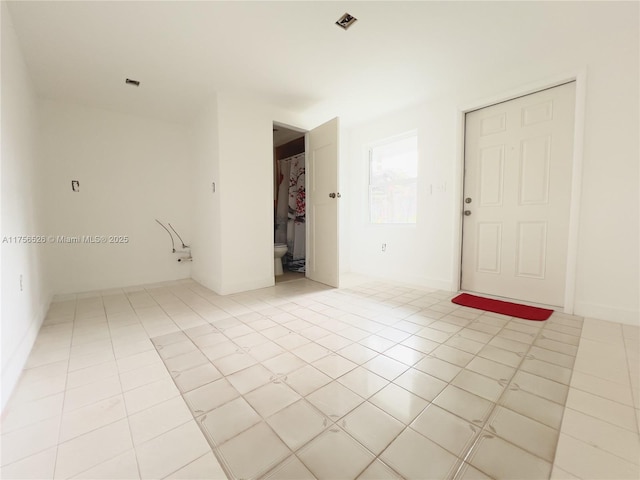 unfurnished room featuring light tile patterned floors