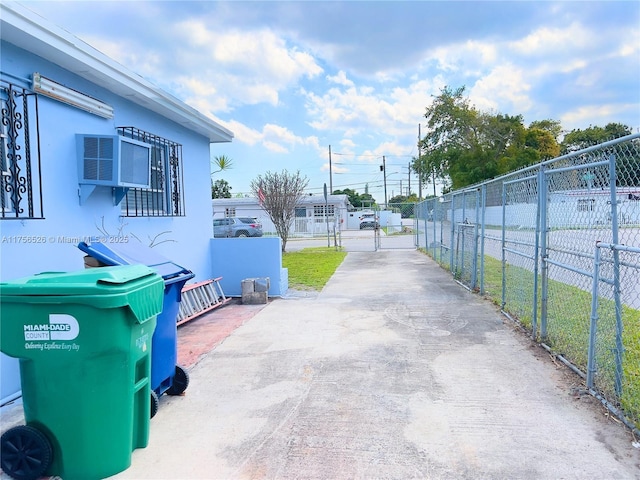 view of street featuring a gate, driveway, and a gated entry