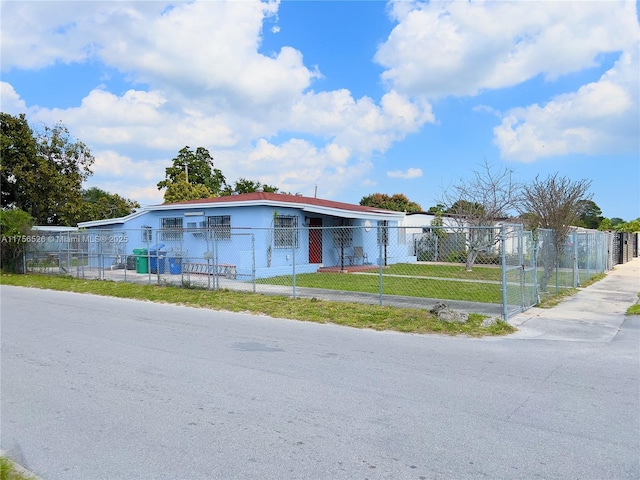 view of front facade with a fenced front yard, a front yard, and a gate