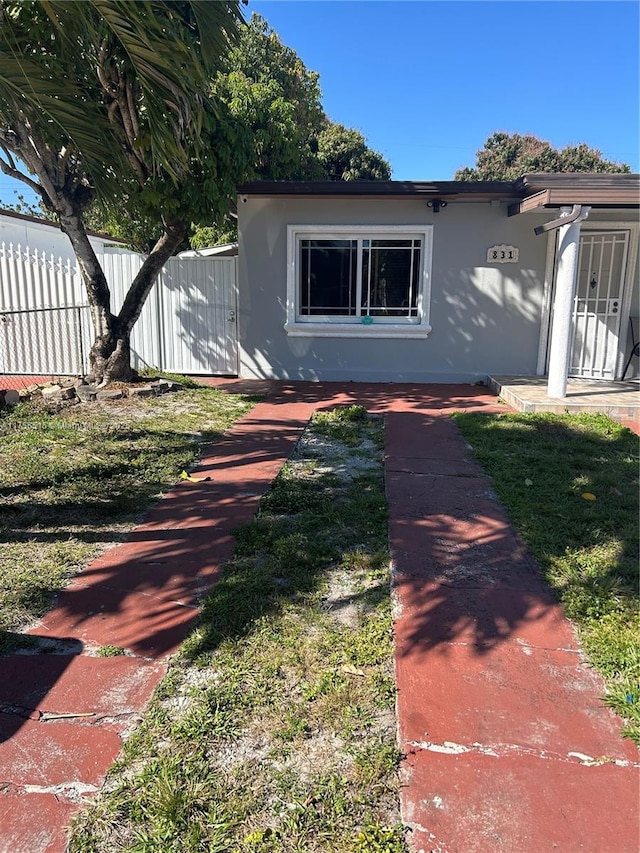 exterior space featuring fence and stucco siding