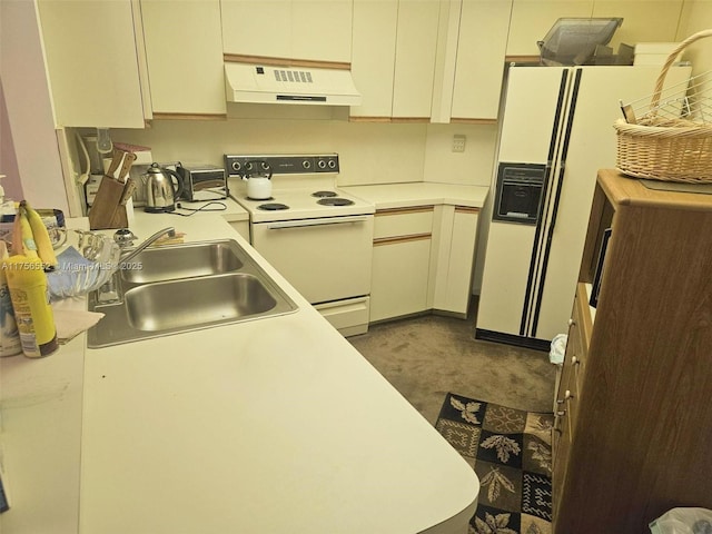 kitchen featuring white appliances, light countertops, under cabinet range hood, dark carpet, and a sink