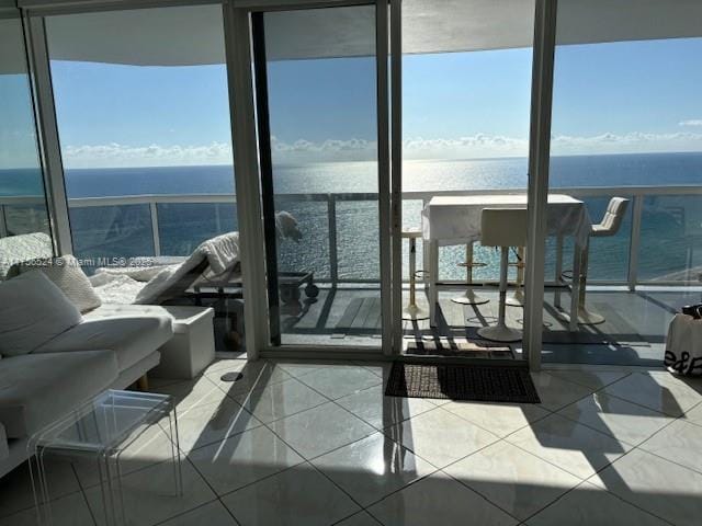 balcony featuring a water view and an outdoor living space