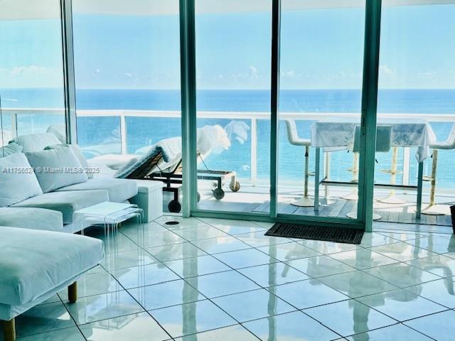 6301 Collins Ave Unit 2802, Miami Beach, FL 33141 - kitchen with appliances with stainless steel finishes, estacked washer and dryer, a breakfast bar area, white cabinetry, and a kitchen island