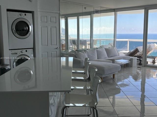 interior space featuring a water view and stacked washer / drying machine