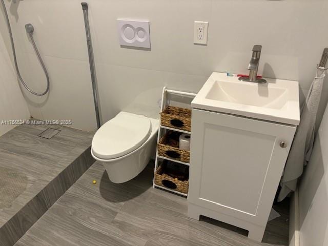 full bathroom with toilet, walk in shower, and vanity