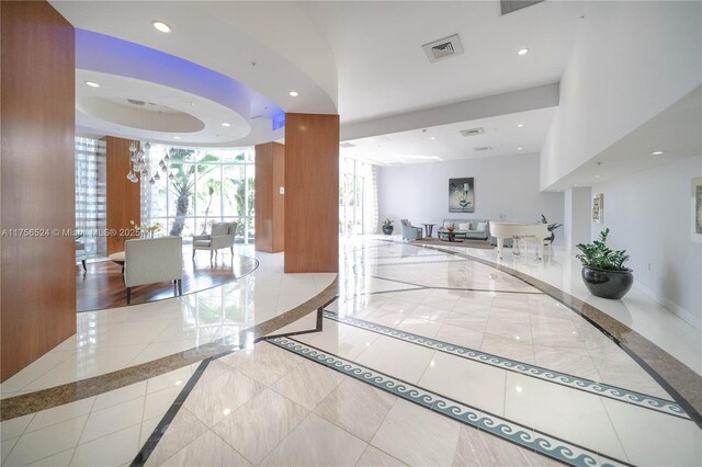 6301 Collins Ave Unit 2802, Miami Beach, FL 33141 - workout area featuring wood finished floors, a tray ceiling, and floor to ceiling windows