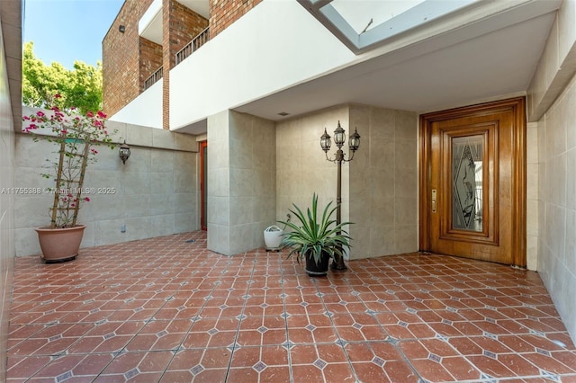 view of exterior entry with a patio area