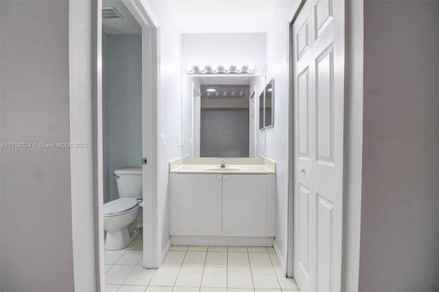 bathroom with toilet, tile patterned flooring, visible vents, and vanity