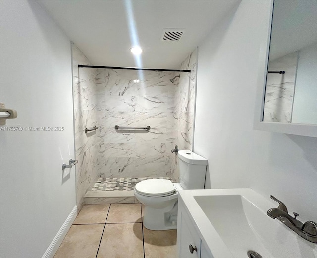 bathroom with a marble finish shower, visible vents, toilet, vanity, and baseboards