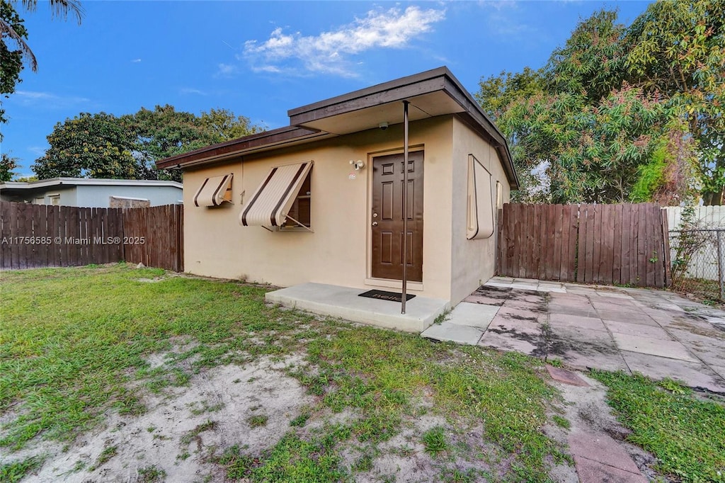 view of outbuilding featuring fence