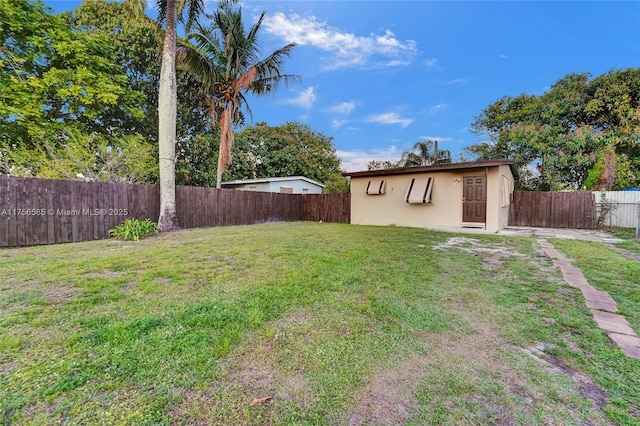 view of yard featuring an outbuilding and a fenced backyard